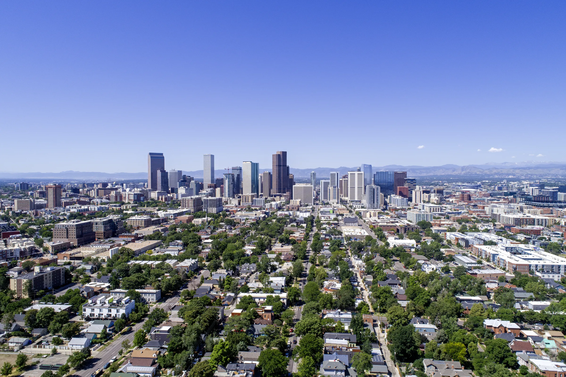 Aerial view of the Denver skyline with the Front Range in the distance.